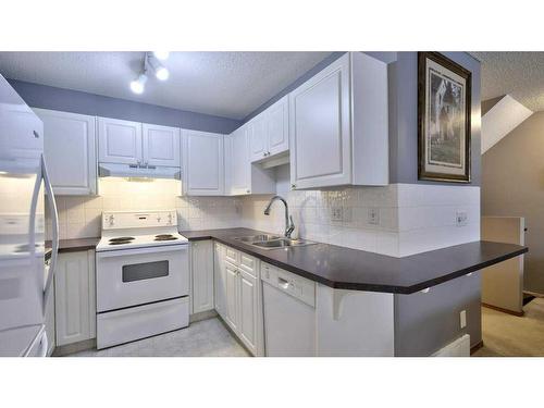 144 Mt Aberdeen Manor Se, Calgary, AB - Indoor Photo Showing Kitchen With Double Sink