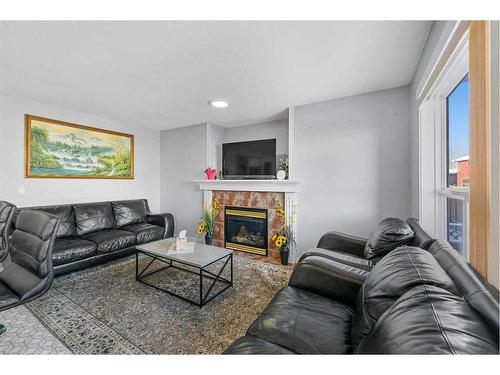 216 Tarawood Place Ne, Calgary, AB - Indoor Photo Showing Living Room With Fireplace