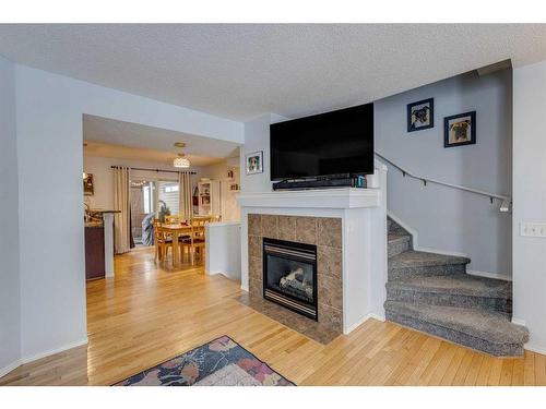 129 Elgin Place Se, Calgary, AB - Indoor Photo Showing Living Room With Fireplace