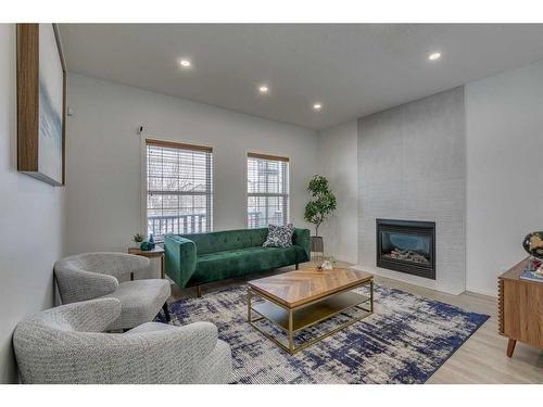 22 Copperstone Green Se, Calgary, AB - Indoor Photo Showing Living Room With Fireplace