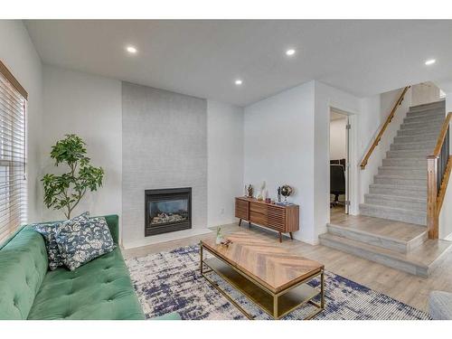 22 Copperstone Green Se, Calgary, AB - Indoor Photo Showing Living Room With Fireplace