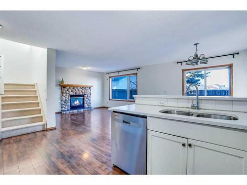 801 Martindale Boulevard Ne, Calgary, AB - Indoor Photo Showing Kitchen With Fireplace With Double Sink