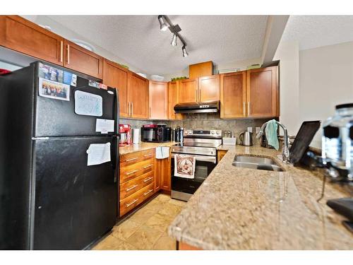 82 Panatella Villas Nw, Calgary, AB - Indoor Photo Showing Kitchen With Double Sink