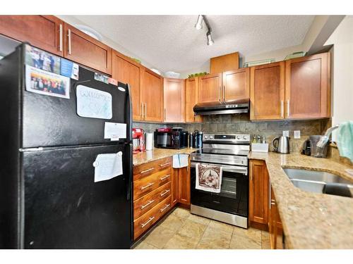 82 Panatella Villas Nw, Calgary, AB - Indoor Photo Showing Kitchen With Double Sink