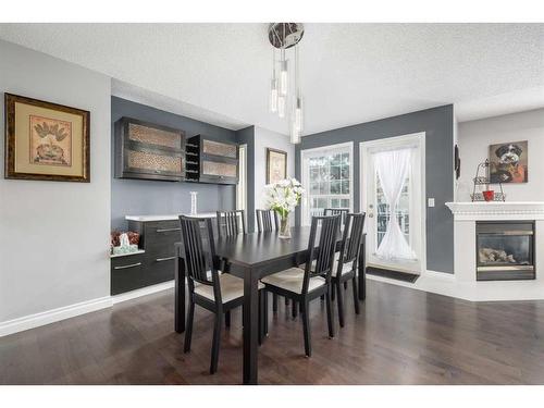 22 Mt Douglas Villas Se, Calgary, AB - Indoor Photo Showing Dining Room With Fireplace