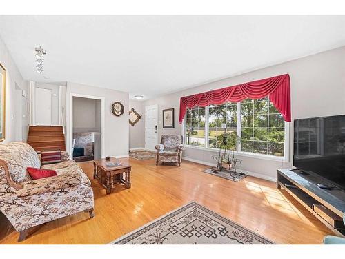 560 Willacy Drive Se, Calgary, AB - Indoor Photo Showing Living Room With Fireplace