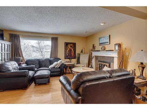 440 Strathcona Mews Sw, Calgary, AB - Indoor Photo Showing Living Room With Fireplace