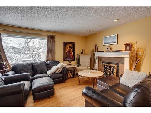 440 Strathcona Mews Sw, Calgary, AB - Indoor Photo Showing Living Room With Fireplace