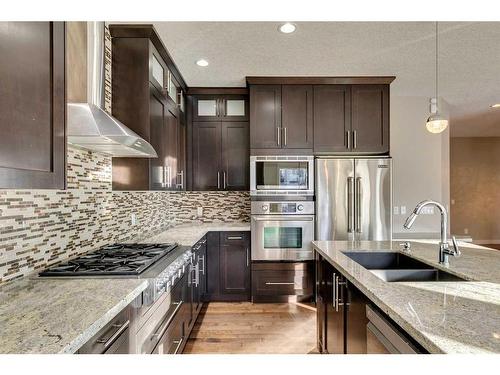 15 Aspen Stone Way Sw, Calgary, AB - Indoor Photo Showing Kitchen With Stainless Steel Kitchen With Double Sink With Upgraded Kitchen