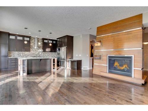 15 Aspen Stone Way Sw, Calgary, AB - Indoor Photo Showing Kitchen With Fireplace With Upgraded Kitchen