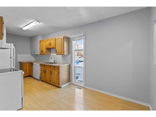 204 Olympia Drive Se, Calgary, AB - Indoor Photo Showing Kitchen With Double Sink