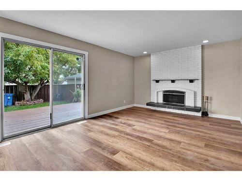 115 Bracewood Way Sw, Calgary, AB - Indoor Photo Showing Living Room With Fireplace