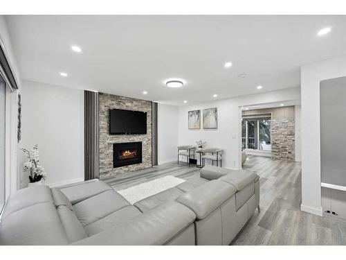 155 Scurfield Place Nw, Calgary, AB - Indoor Photo Showing Living Room With Fireplace