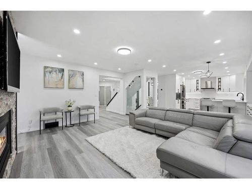 155 Scurfield Place Nw, Calgary, AB - Indoor Photo Showing Living Room With Fireplace