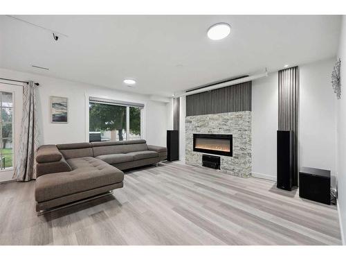 155 Scurfield Place Nw, Calgary, AB - Indoor Photo Showing Living Room With Fireplace