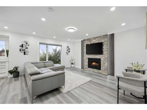 155 Scurfield Place Nw, Calgary, AB - Indoor Photo Showing Living Room With Fireplace