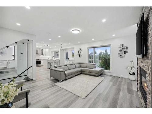 155 Scurfield Place Nw, Calgary, AB - Indoor Photo Showing Living Room With Fireplace