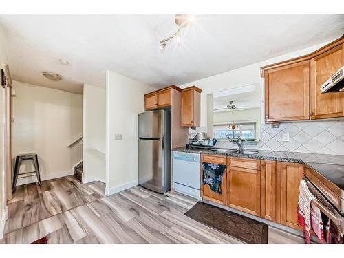 9 Dover Mews Se, Calgary, AB - Indoor Photo Showing Kitchen With Double Sink