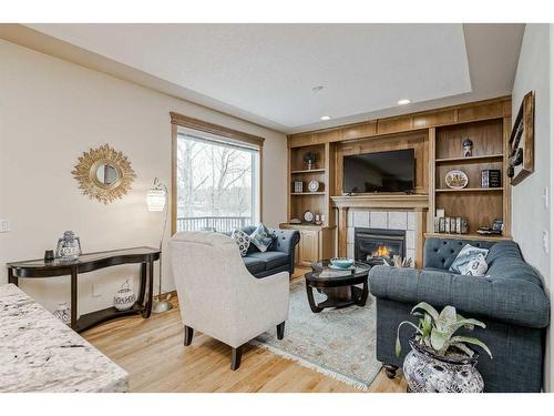 191 Rocky Ridge Landing Nw, Calgary, AB - Indoor Photo Showing Living Room With Fireplace