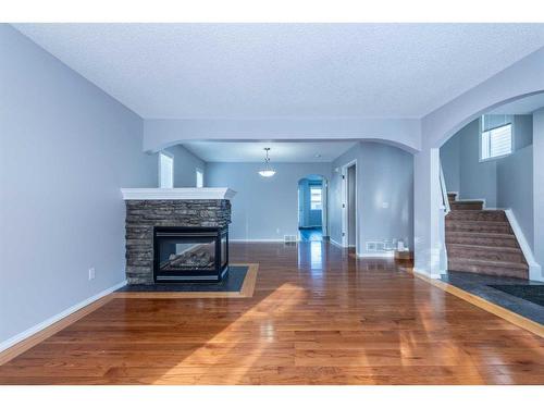 96 Taradale Drive Ne, Calgary, AB - Indoor Photo Showing Living Room With Fireplace