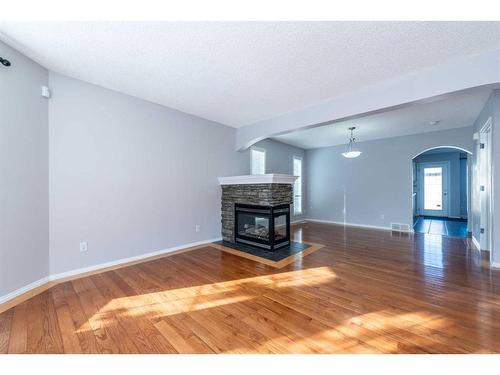 96 Taradale Drive Ne, Calgary, AB - Indoor Photo Showing Living Room With Fireplace