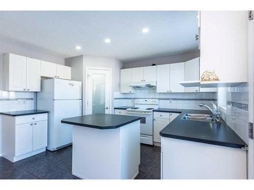 96 Taradale Drive Ne, Calgary, AB - Indoor Photo Showing Kitchen With Double Sink