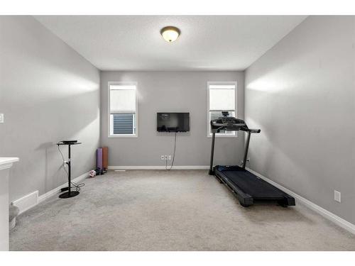 99 Evansfield Rise Nw, Calgary, AB - Indoor Photo Showing Gym Room