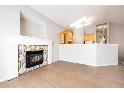 214 Erin Circle Se, Calgary, AB - Indoor Photo Showing Living Room With Fireplace