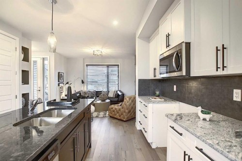 322 Sundown Road, Cochrane, AB - Indoor Photo Showing Kitchen With Double Sink With Upgraded Kitchen