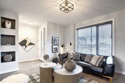 322 Sundown Road, Cochrane, AB - Indoor Photo Showing Living Room With Fireplace