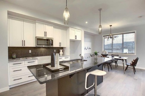 322 Sundown Road, Cochrane, AB - Indoor Photo Showing Kitchen With Upgraded Kitchen