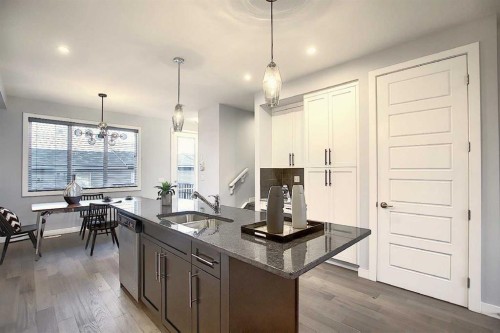 322 Sundown Road, Cochrane, AB - Indoor Photo Showing Kitchen With Double Sink With Upgraded Kitchen