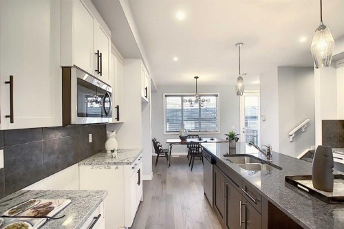 322 Sundown Road, Cochrane, AB - Indoor Photo Showing Kitchen With Double Sink With Upgraded Kitchen