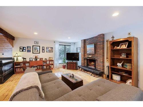 107 Oakfern Way Sw, Calgary, AB - Indoor Photo Showing Living Room With Fireplace