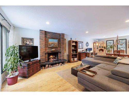 107 Oakfern Way Sw, Calgary, AB - Indoor Photo Showing Living Room With Fireplace