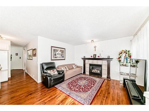 76 Bridleridge Gardens Sw, Calgary, AB - Indoor Photo Showing Living Room With Fireplace