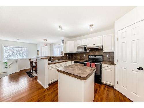 76 Bridleridge Gardens Sw, Calgary, AB - Indoor Photo Showing Kitchen With Double Sink