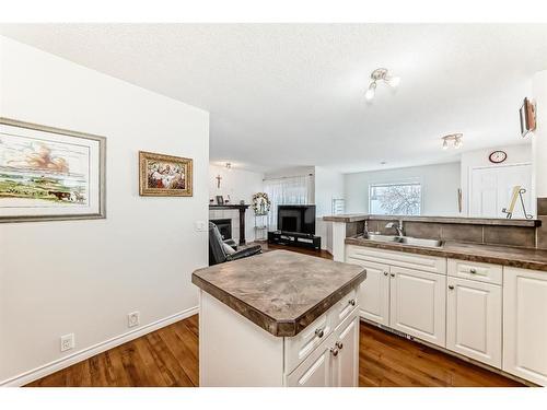 76 Bridleridge Gardens Sw, Calgary, AB - Indoor Photo Showing Kitchen With Double Sink