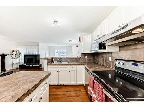 76 Bridleridge Gardens Sw, Calgary, AB - Indoor Photo Showing Kitchen With Double Sink