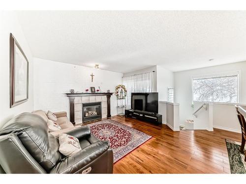 76 Bridleridge Gardens Sw, Calgary, AB - Indoor Photo Showing Living Room With Fireplace