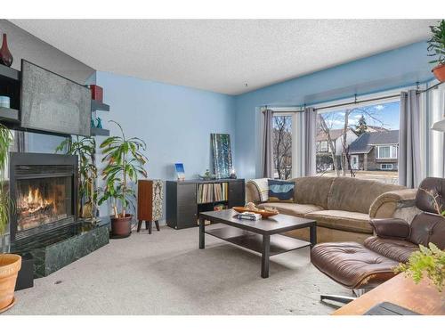 204 Macewan Glen Drive Nw, Calgary, AB - Indoor Photo Showing Living Room With Fireplace