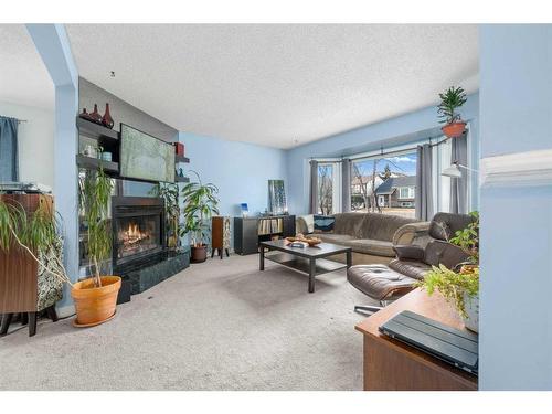 204 Macewan Glen Drive Nw, Calgary, AB - Indoor Photo Showing Living Room With Fireplace