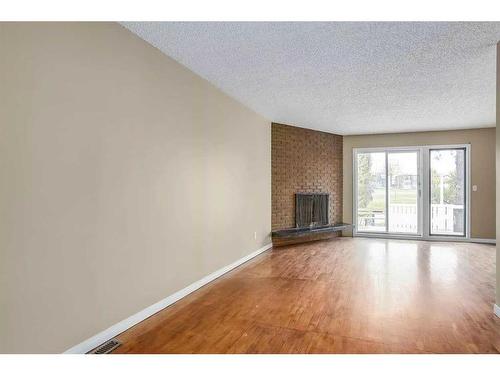 240 30 Avenue Ne, Calgary, AB - Indoor Photo Showing Other Room With Fireplace