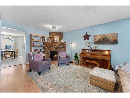 59 Mt Apex Green Se, Calgary, AB - Indoor Photo Showing Living Room With Fireplace