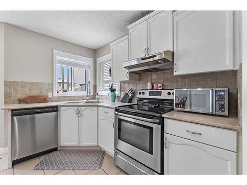 59 Mt Apex Green Se, Calgary, AB - Indoor Photo Showing Kitchen With Double Sink