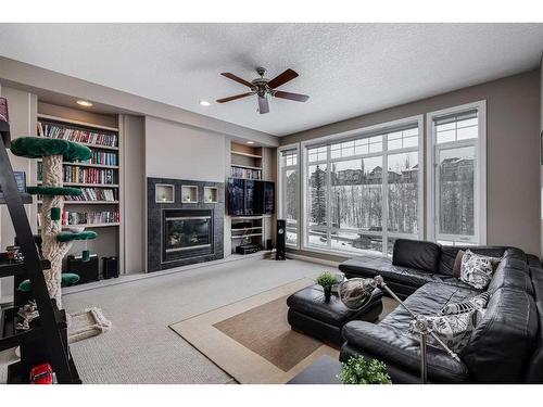 69 Discovery Ridge Hill Sw, Calgary, AB - Indoor Photo Showing Living Room With Fireplace