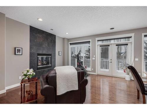 69 Discovery Ridge Hill Sw, Calgary, AB - Indoor Photo Showing Living Room With Fireplace