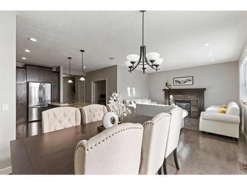 7 Copperleaf Terrace Se, Calgary, AB - Indoor Photo Showing Dining Room With Fireplace