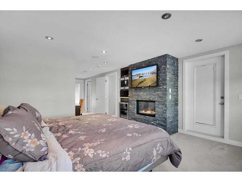 1907 Westmount Road Nw, Calgary, AB - Indoor Photo Showing Bedroom With Fireplace