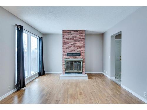 172 Abinger Crescent Ne, Calgary, AB - Indoor Photo Showing Living Room With Fireplace